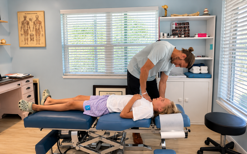 Physiotherapist assessing young athlete posture